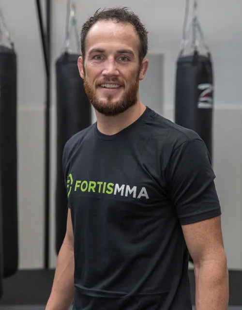 Damon Jackson in a Fortis MMA shirt at the gym